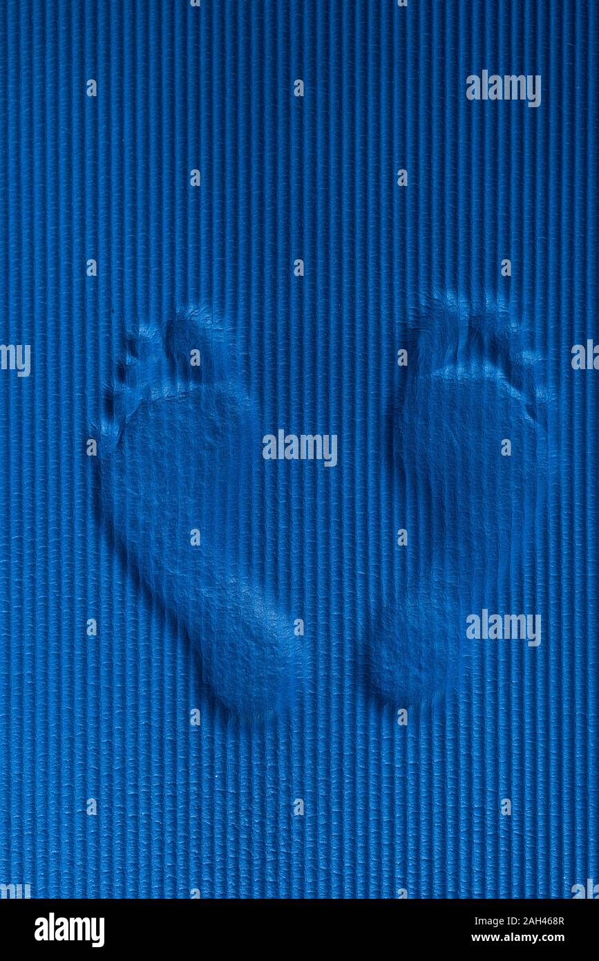 Footmarks on blue workout mat Stock Photo