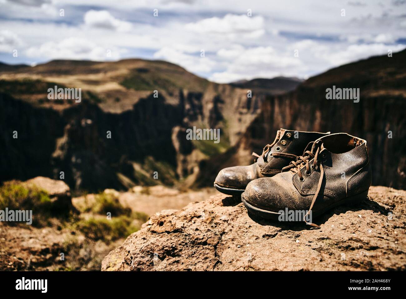 Old hiking boots on top of a hill at Maletsunyane Falls, Lesotho Stock Photo