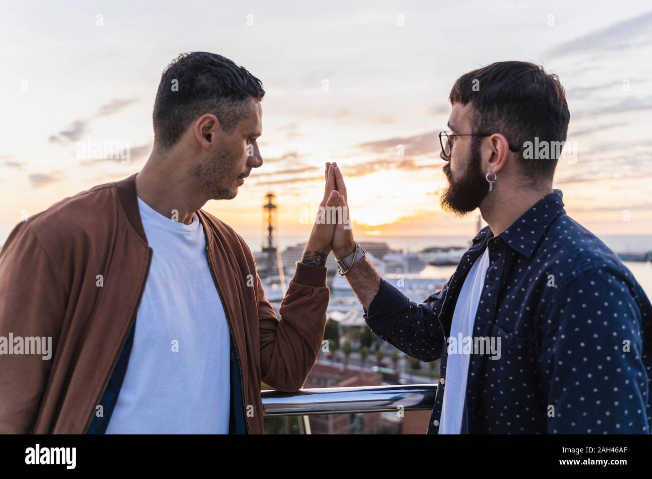 Gay couple on lookout above the city with view to the port, Barcelona,  Spain Stock Photo - Alamy