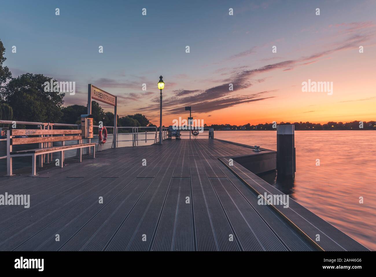 Germany, Hamburg, Pier on Outer Alster lake at sunrise Stock Photo