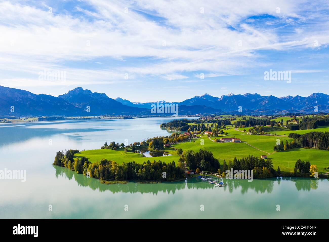 Germany, Bavaria, Dietringen, Aerial view of Forggensee lake with mountains in background Stock Photo