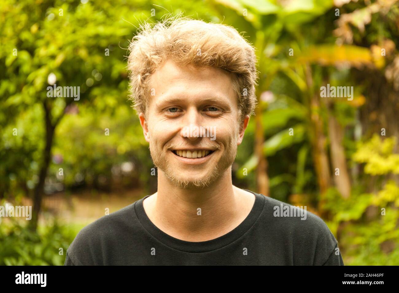 Portrait of smiling young strawberry blonde man Stock Photo