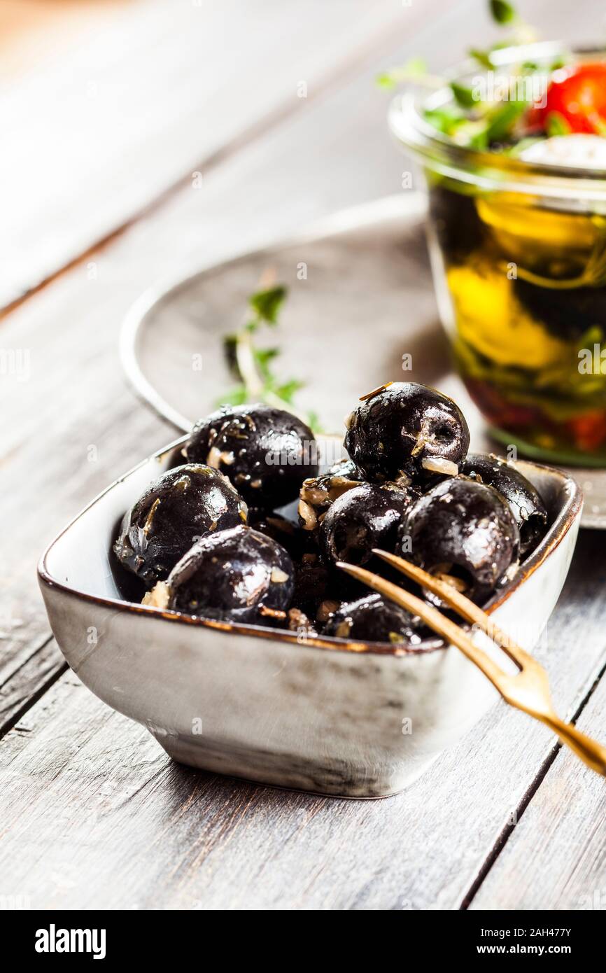 Bowl of black olives with garlic Stock Photo Alamy