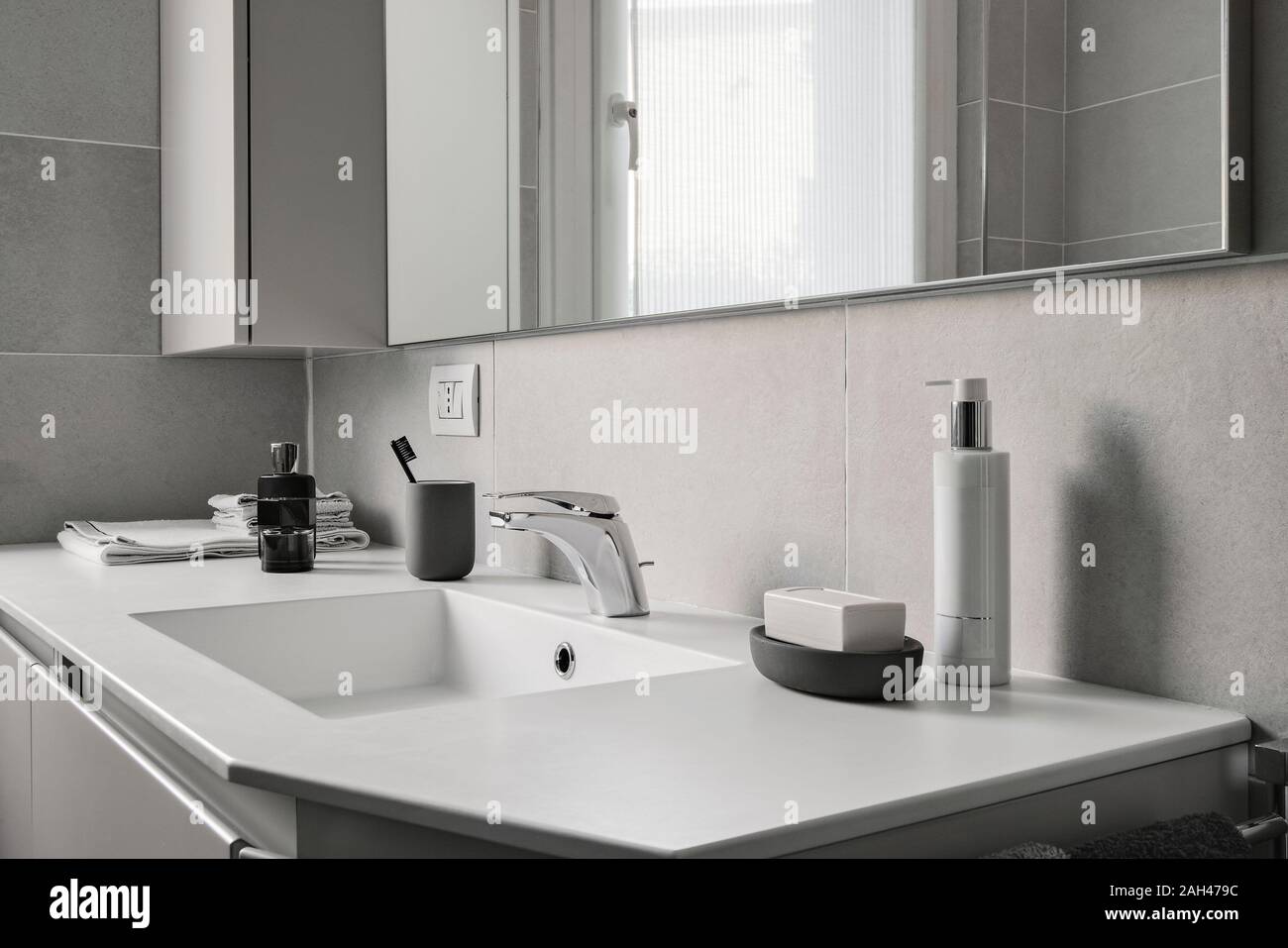 interior shot of a modern bathroom in foreground the integrated washbasin with faucet Stock Photo