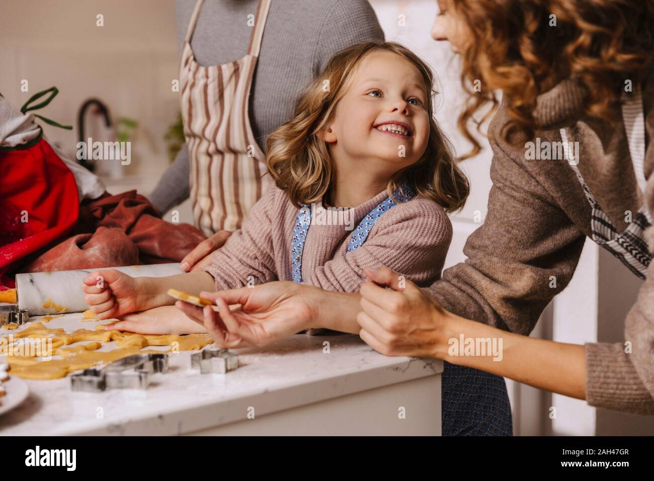 Happy family preparing Christmas cookies in kitchen Stock Photo