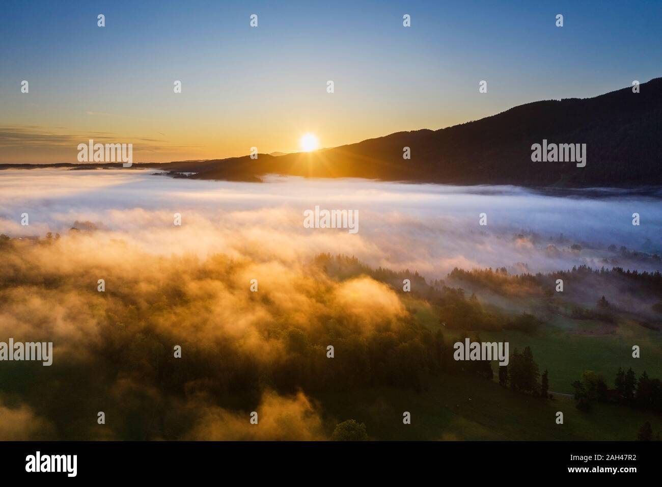 Germany, Upper Bavaria, Gaissach, Aerial view of fog above landscape at sunrise Stock Photo