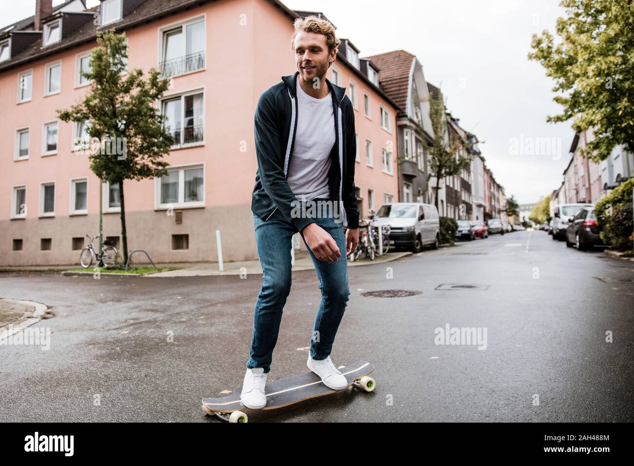 Young man on longboard Stock Photo