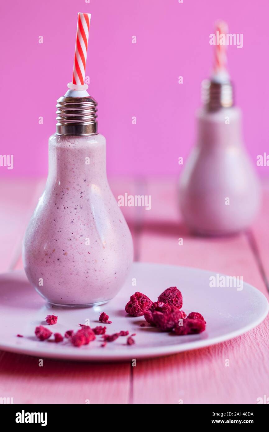 Pink vegan milkshake served in light bulb Stock Photo
