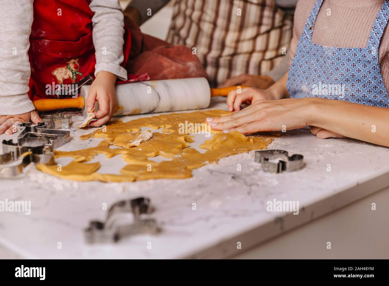 Family preparing Christmas cookies in kitchen Stock Photo