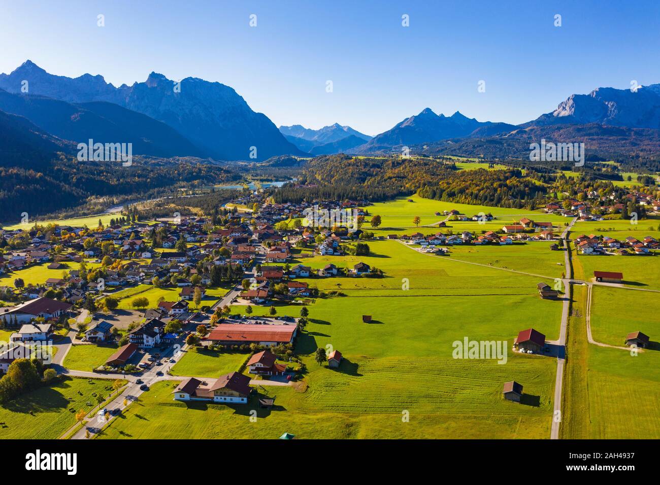 Germany, Bavaria, Upper Bavaria, Werdenfelser Land, Krun, Aerial view of fields and village with Karwendel Mountains and Wetterstein Mountains in background Stock Photo