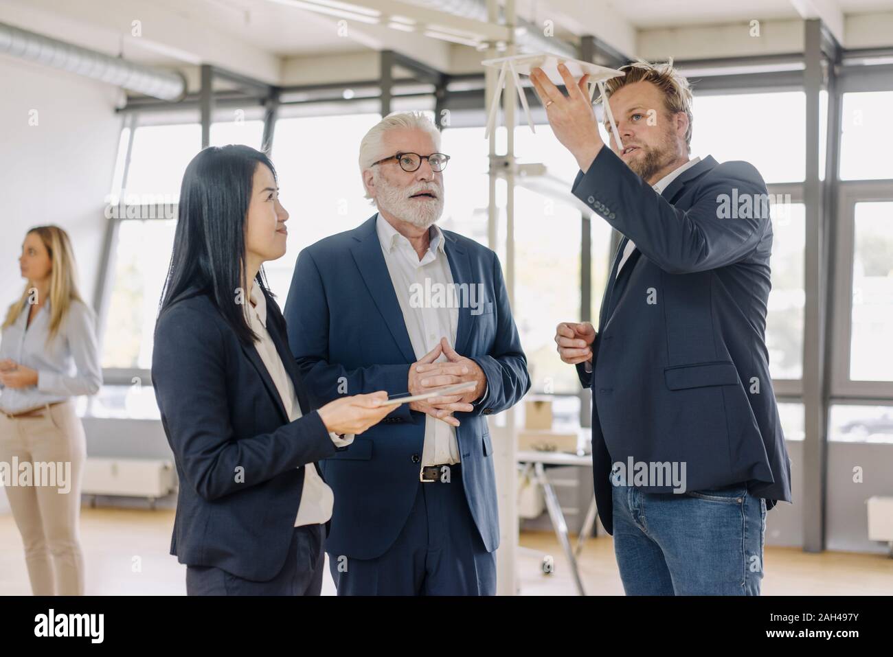 Business people having a meeting in office discussing a model Stock Photo