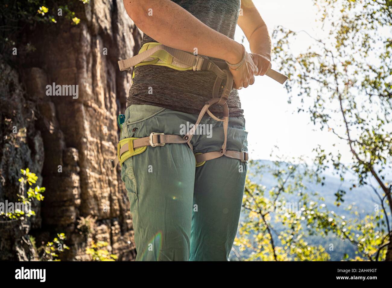 Woman putting climbing harness hi-res stock photography and images - Alamy