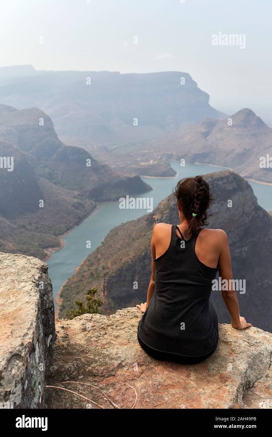 Woman sitting on the top of a rock at Blyde River Canyon, South Africa Stock Photo