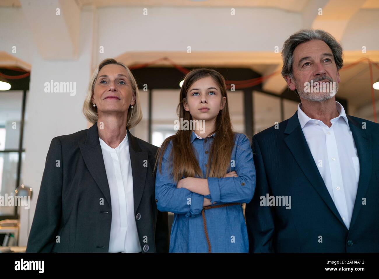 Portrait of confident businessman and businesswoman with girl in office Stock Photo