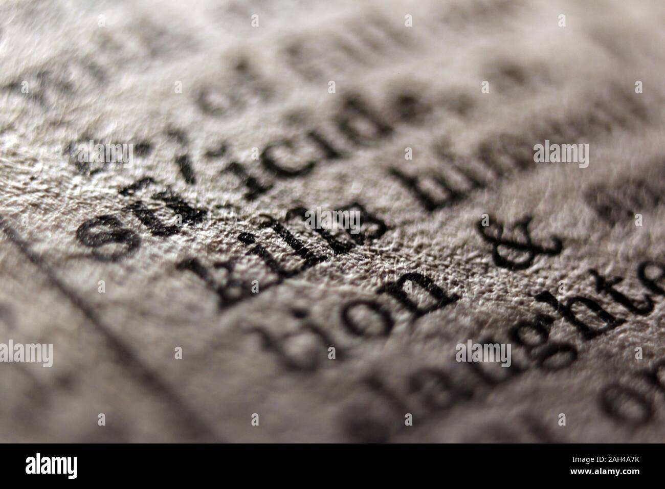 Word "suicide" printed on book page, close-up Stock Photo