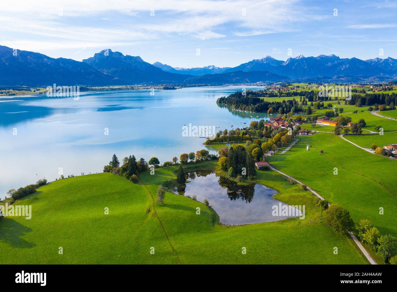 Germany, Bavaria, Dietringen, Aerial view of Forggensee lake with mountains in background Stock Photo