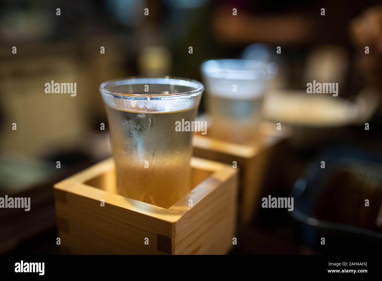 Japan, Takayama, Sake served in masu in traditional Japanese restaurant Stock Photo