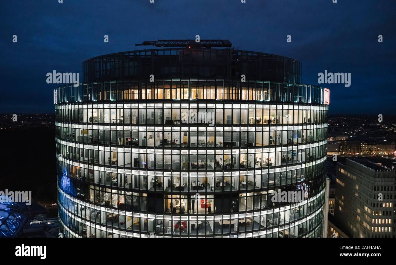 View to lighted modern office building at night, Potsdamer Platz, Berlin, Germany Stock Photo