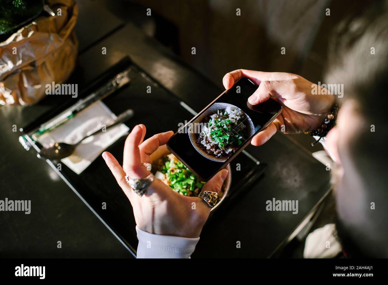 Man's hands with smartphone taking a picture of his dinner Stock Photo