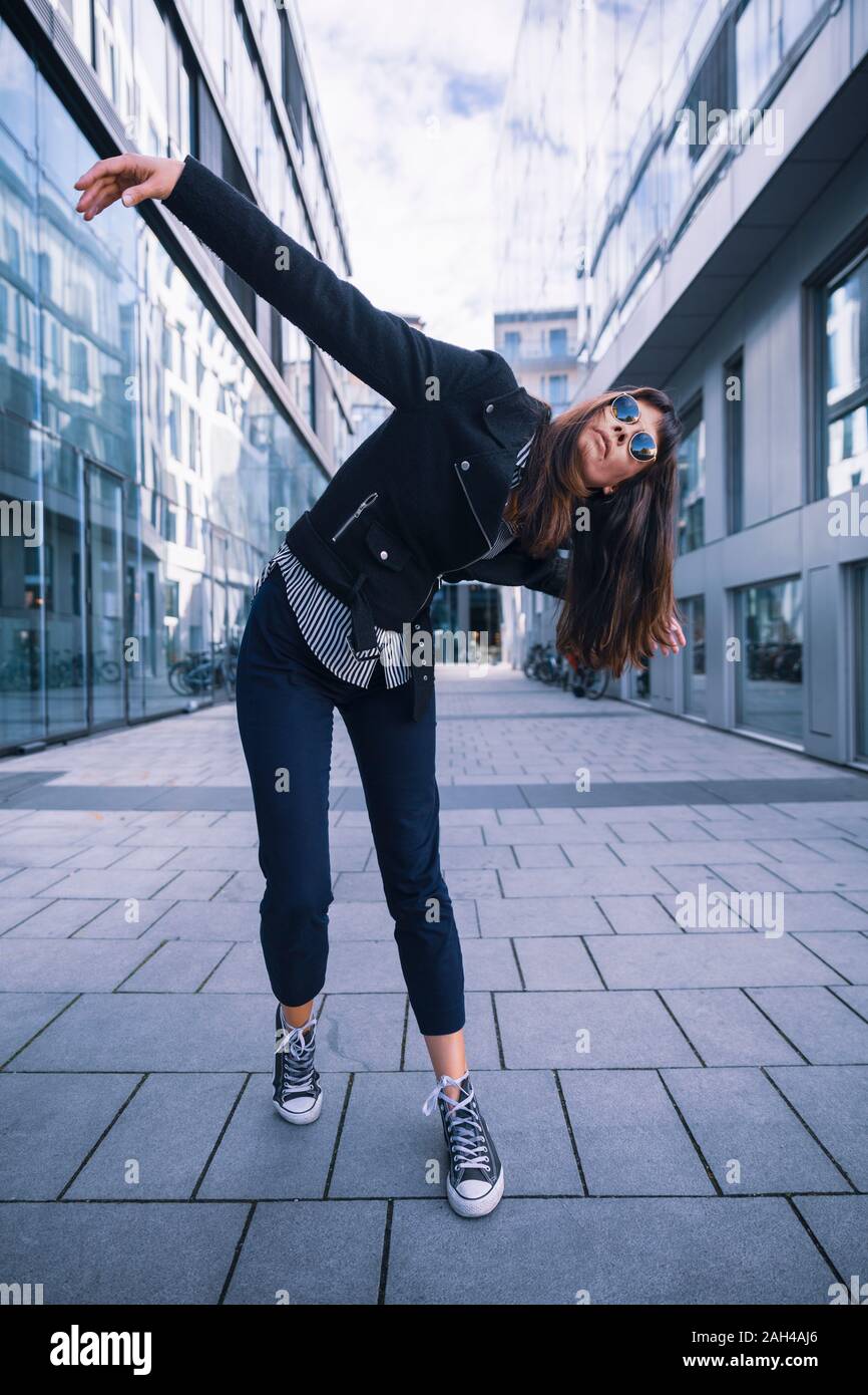 Women with sun glasses in urban location, posing artistically Stock Photo