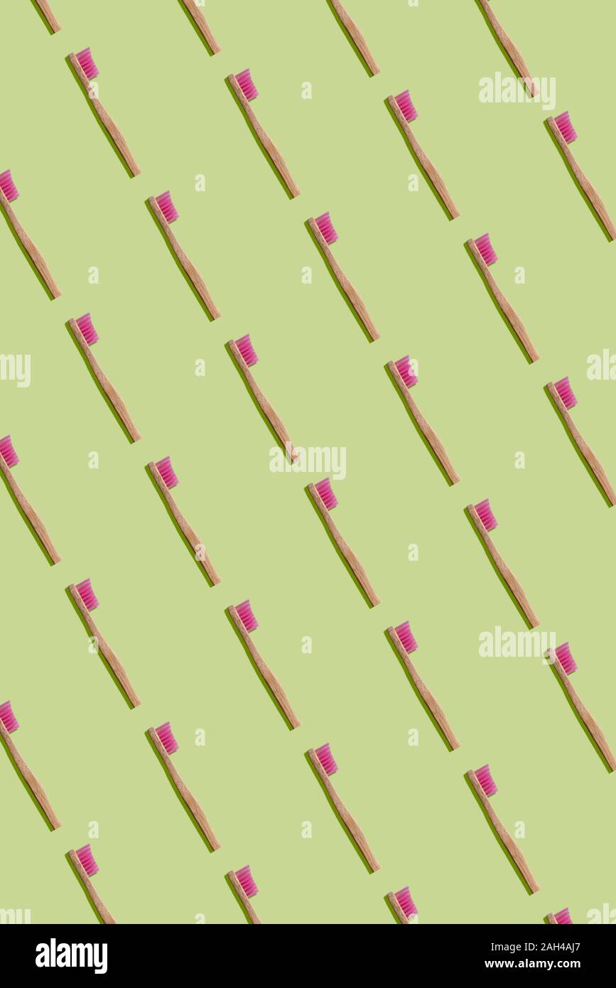 Sustainable and plastic free bamboo toothbrushes pattern on green background Stock Photo