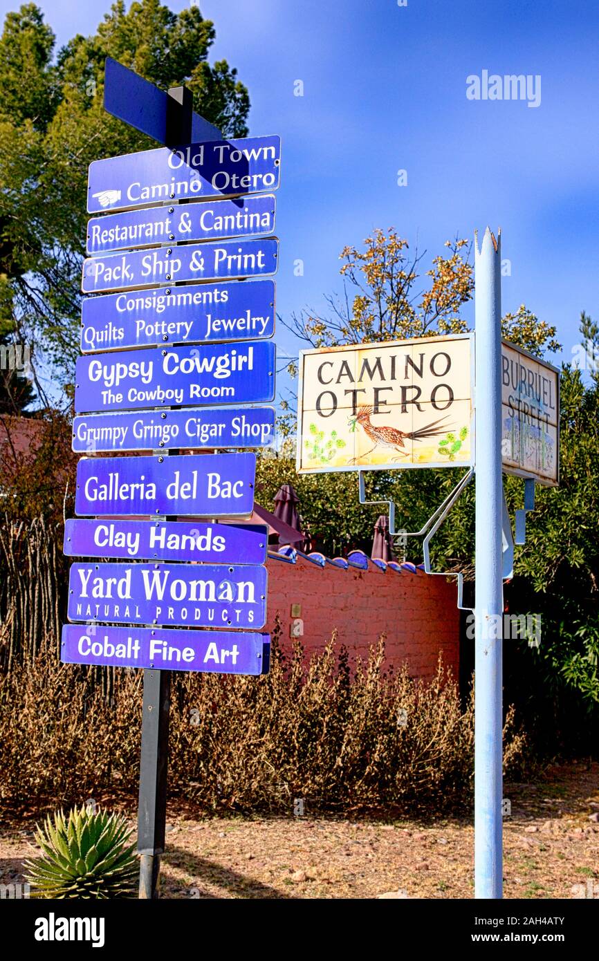 Blue store direction signs and ceramic tile street sign at he corner of