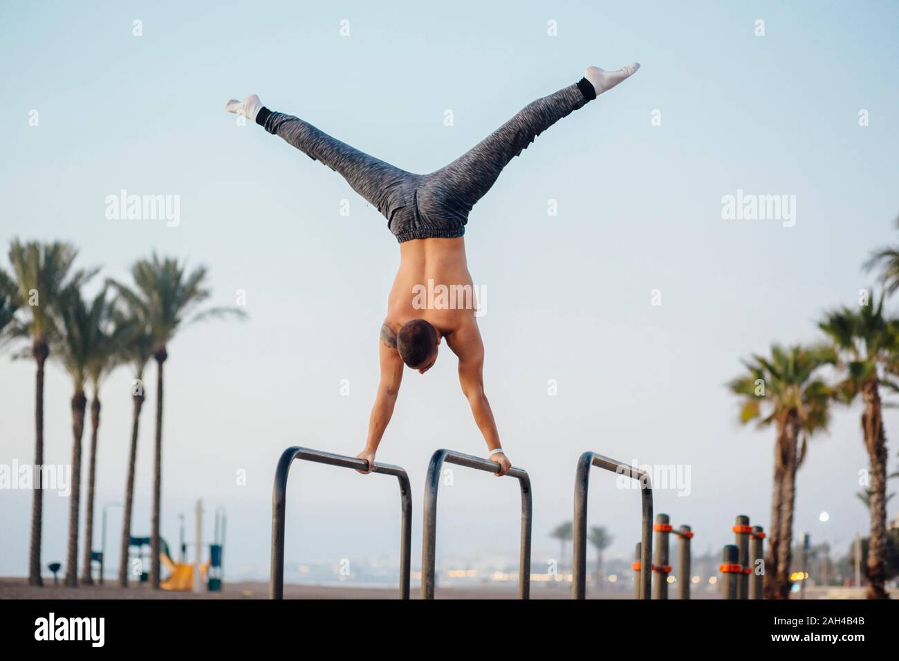 Young man practicing calisthenics at an outdoor gym Stock Photo - Alamy