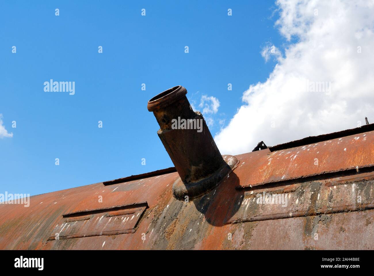 Mouth of the bulk-oil tank on a background of the blue sky with a cloud Stock Photo