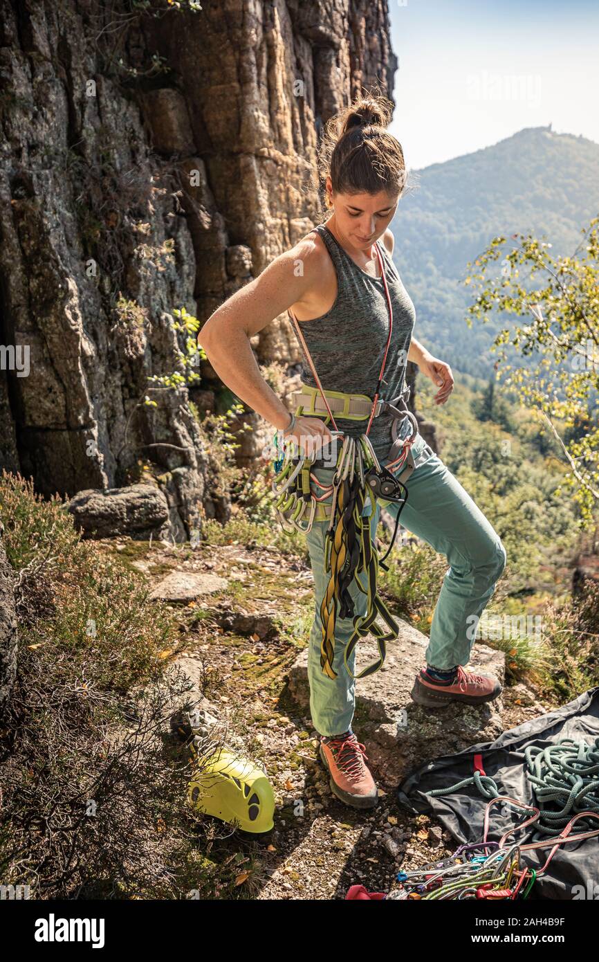 Woman putting climbing harness hi-res stock photography and images - Alamy