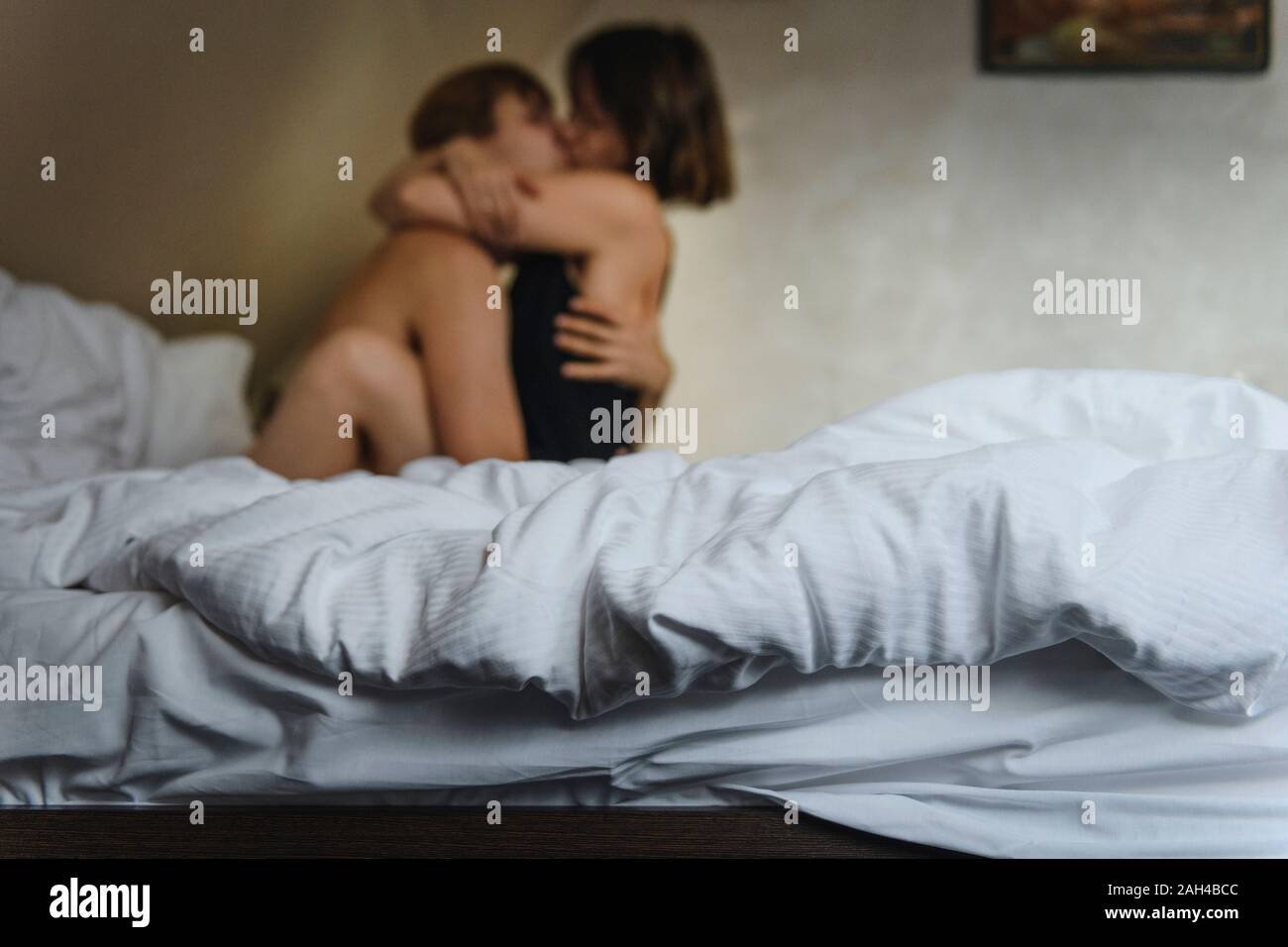 Couple hugging and kissing on bed Stock Photo