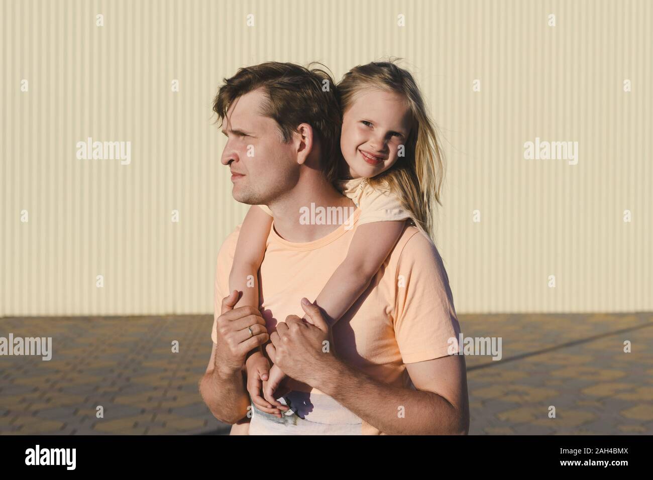 Father carrying his little daughter piggyback Stock Photo