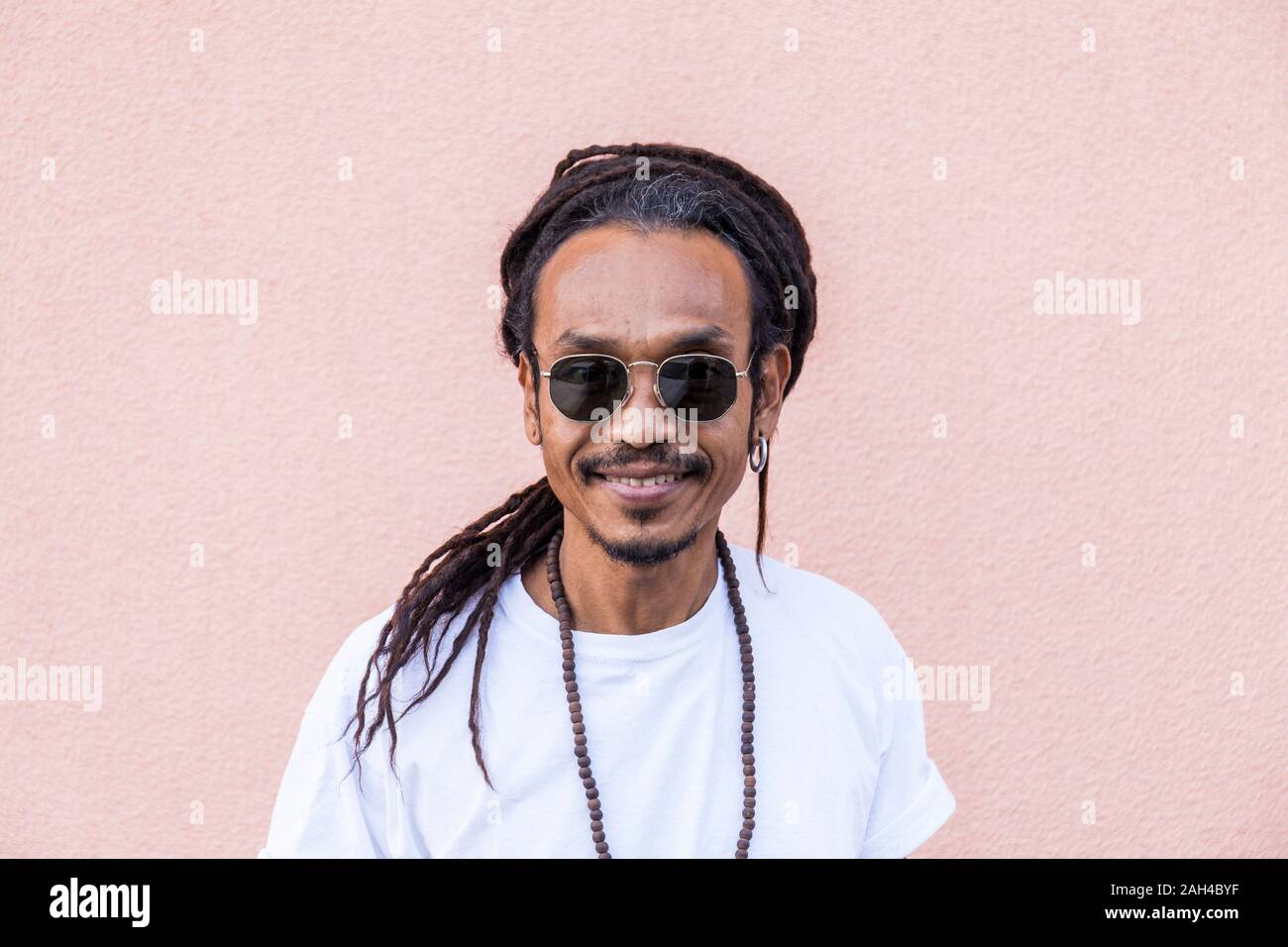 Portrait of smiling mature man with dreadlocks and sunglasses Stock ...