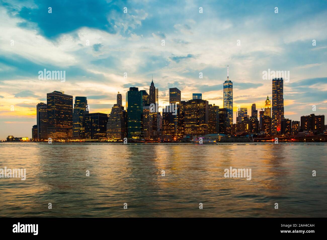 USA, New York, New York City, Manhattan skyline illuminated at dusk Stock Photo