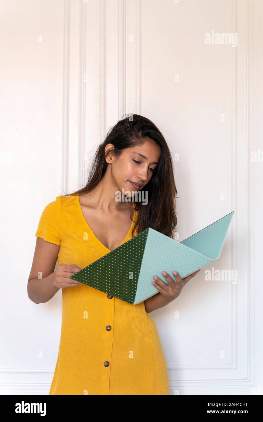 Young woman looking in folder Stock Photo