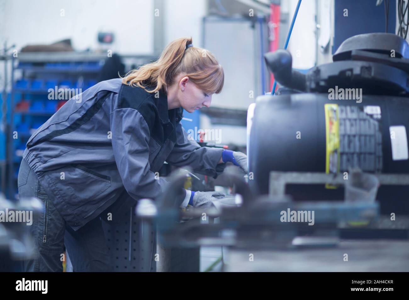 Female car mechanic working in repair garage Stock Photo