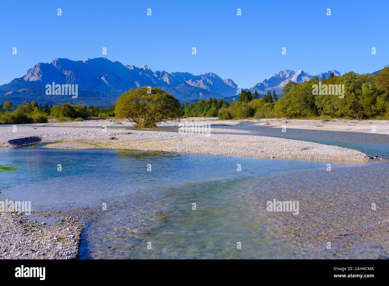 Germany, Bavaria, Wallgau, Scenic view of Isar river with Wetterstein Mountains looming in background Stock Photo