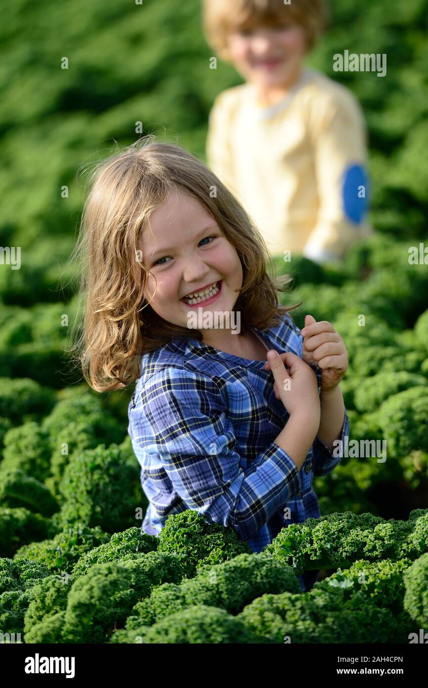 Smiling girl and boy in a kali field Stock Photo
