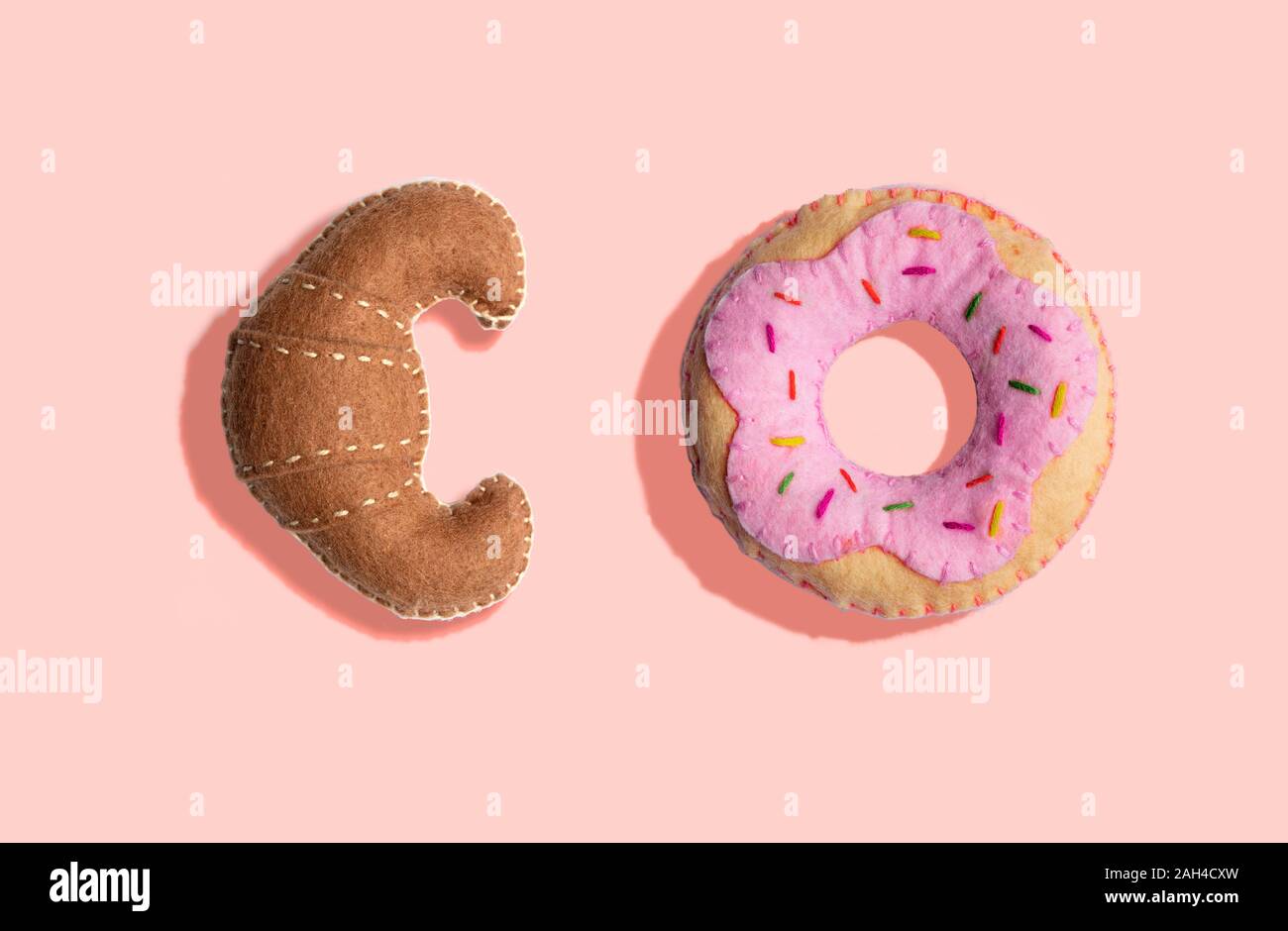 3D Illustration, Plush fake croissant and donut pattern on light pink background Stock Photo