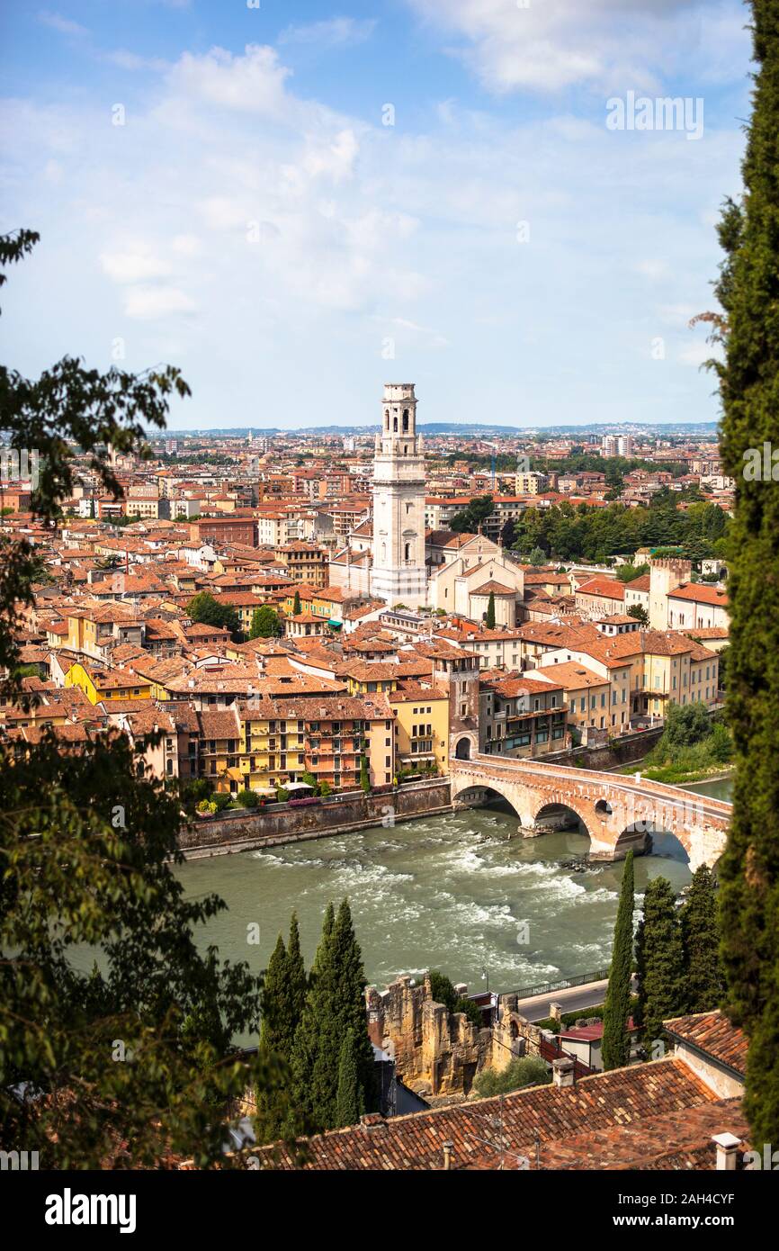 Italy, Verona, Ponte Pietra bridge and surrounding city buildings Stock Photo