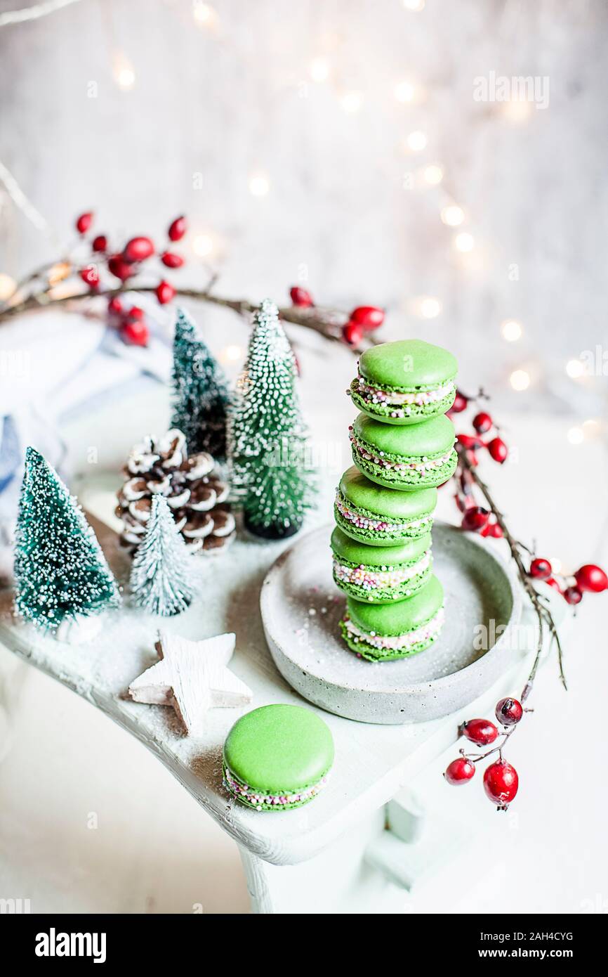 Stack of green macaroons and Christmas decorations Stock Photo