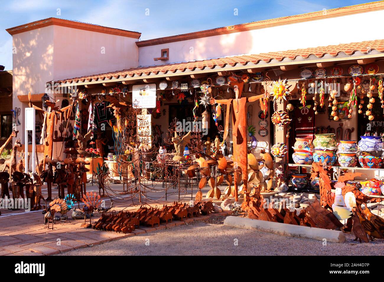 Glazed colorful Mexican pots, stonewear and metal sculptures outside