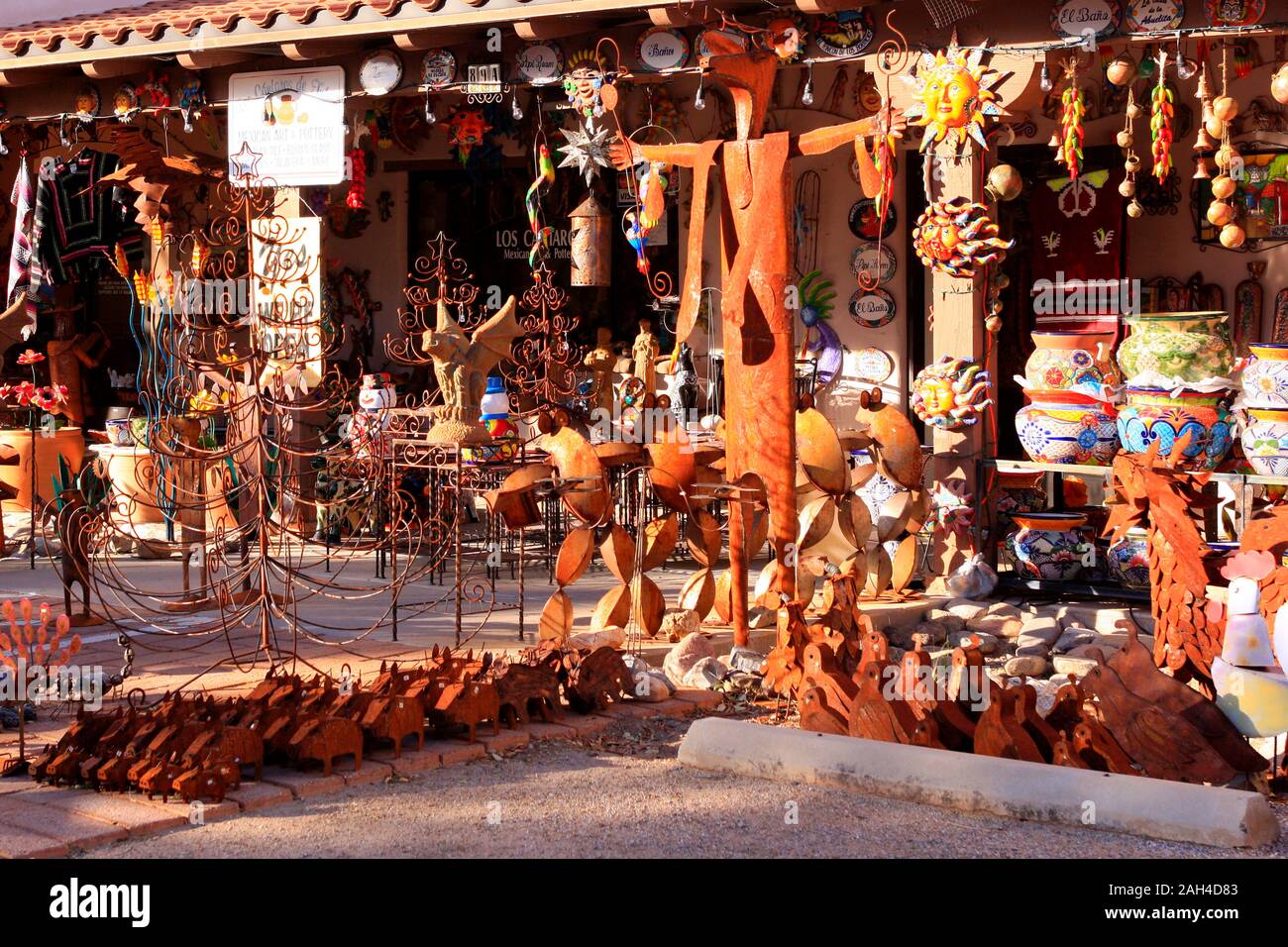 Glazed colorful Mexican pots, stonewear and metal sculptures outside