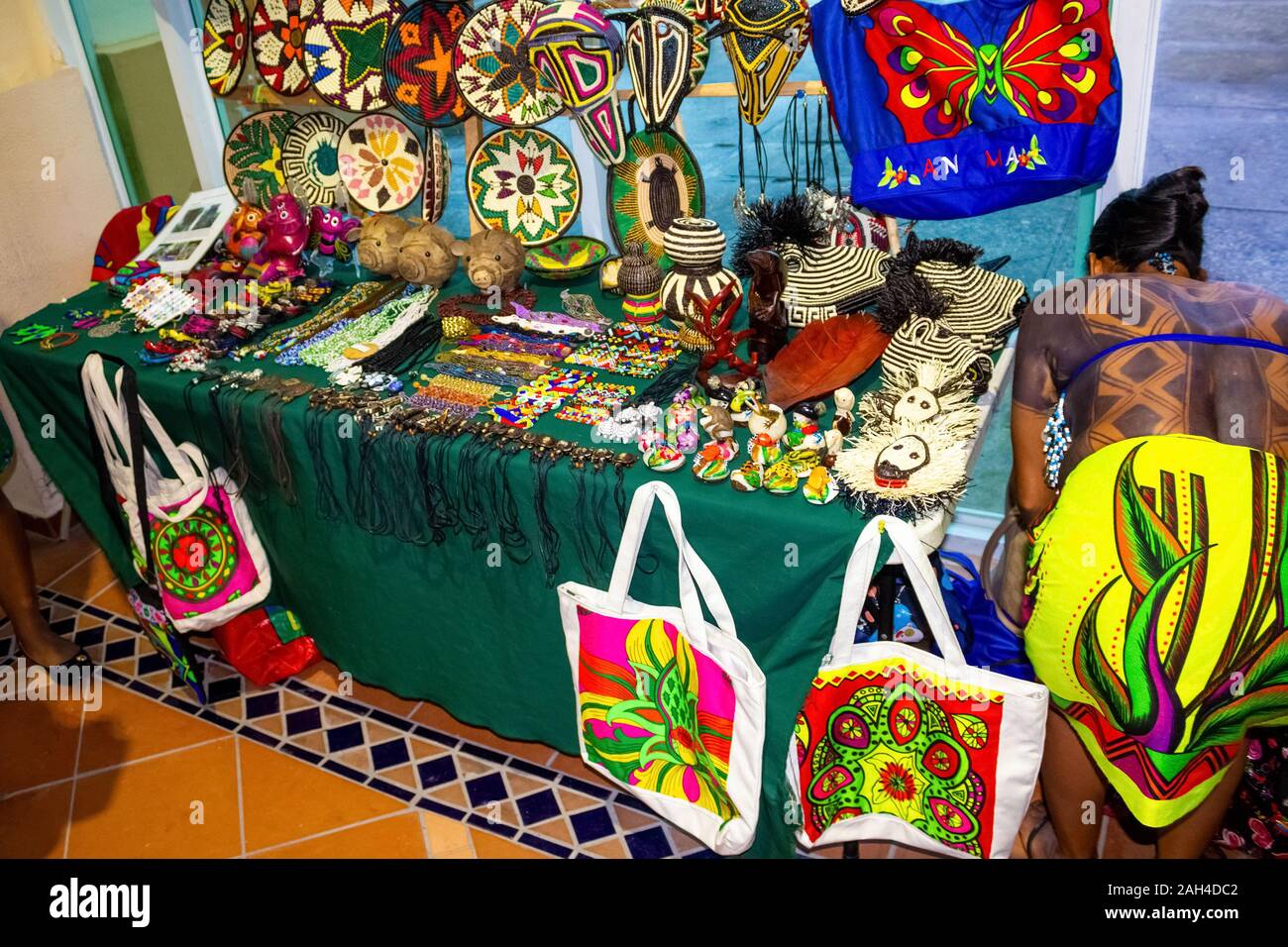 Ethnic souvenirs, baseball caps, bags with various pattern hanging in
