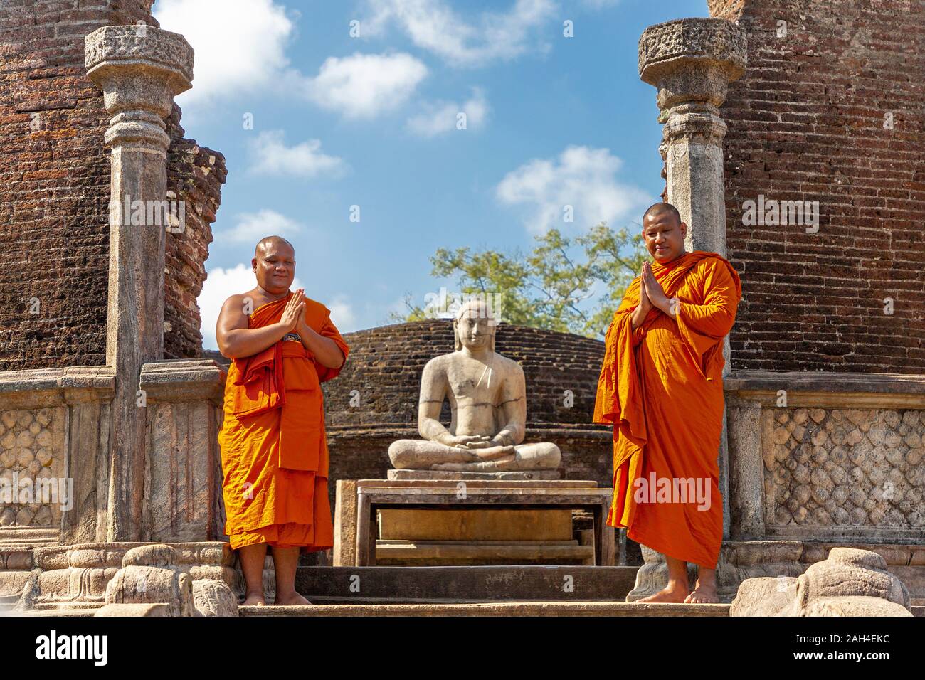 Buddhist monks in the remains of the ancient city of Polonnaruwa, in Polonnaruwa, Sri Lanka Stock Photo