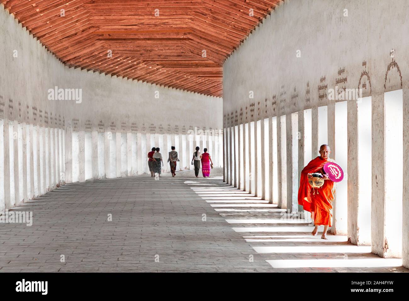 Buddhist monk walking in the entry hall of the temple, in Bagan, Myanmar Stock Photo