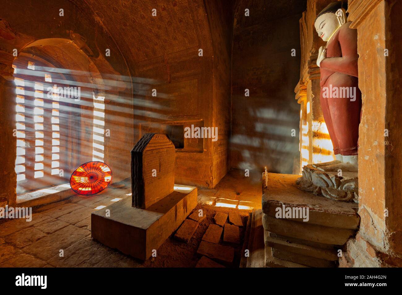 Ancient Buddhist temple with light rays through its window in Bagan, Myanmar Stock Photo