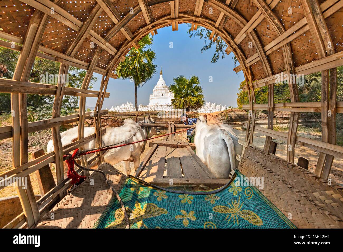 White pagoda known as Hsinbyume, located near Mingun, through the cover of ox cart, in Mandalay, Myanmar. Stock Photo