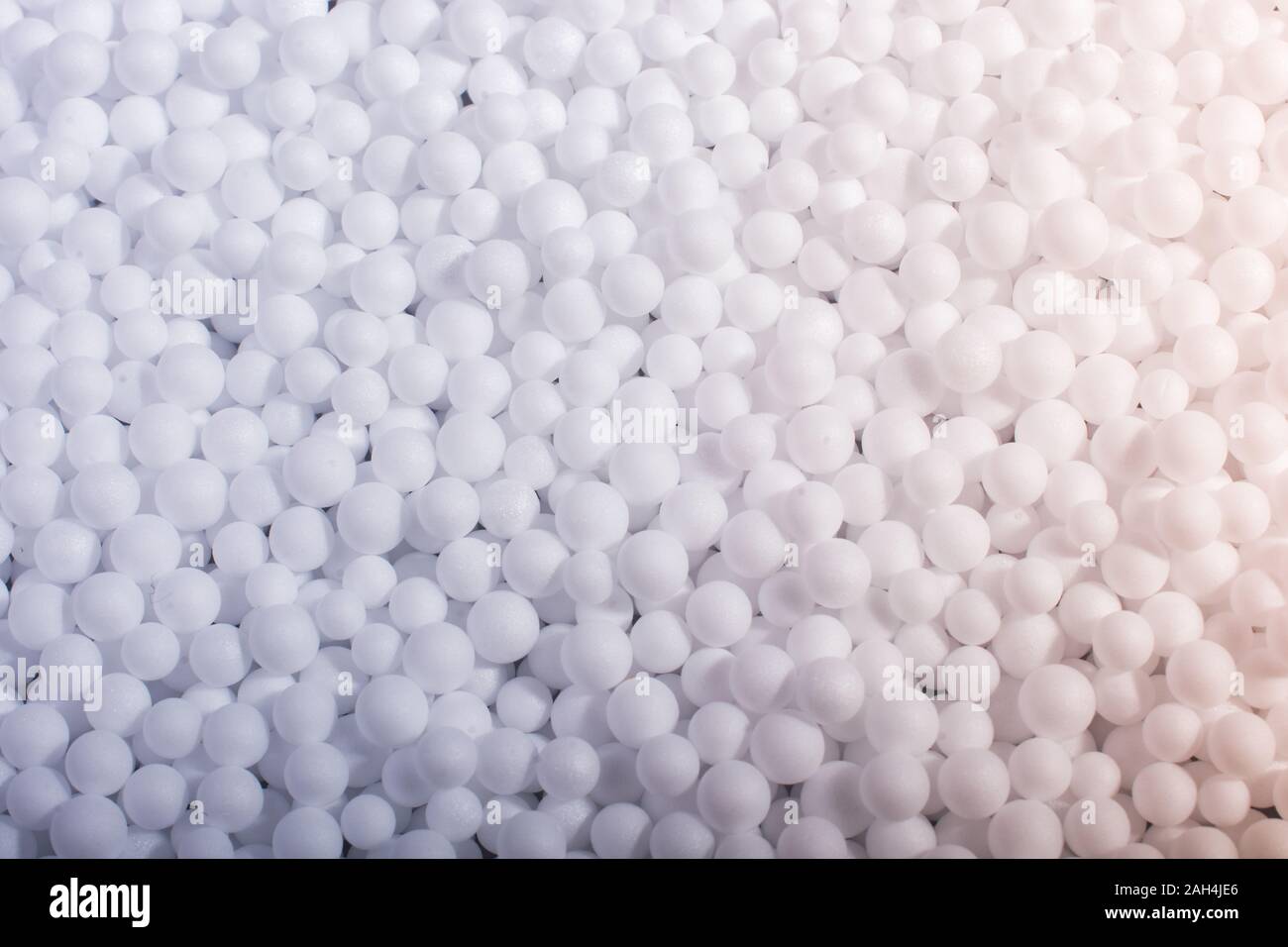 White little polystyrene foam balls as background Stock Photo - Alamy