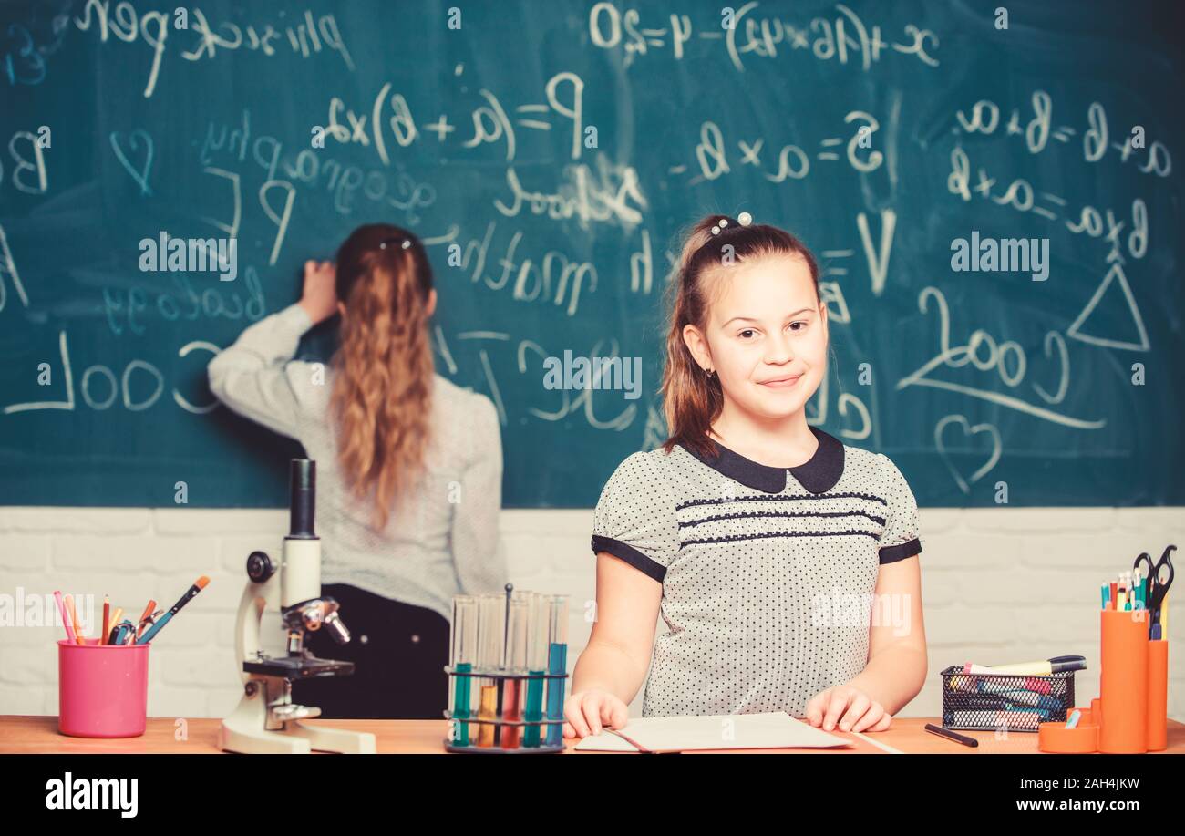 Smart and confident. Little girls in school lab. Chemistry education. Biology lesson. science experiments in chemistry laboratory. Chemistry research. Little scientist work with microscope. Stock Photo