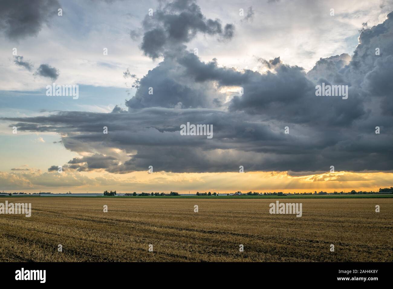 Dramatic storm clouds are forming over the wide open dutch landscape ...